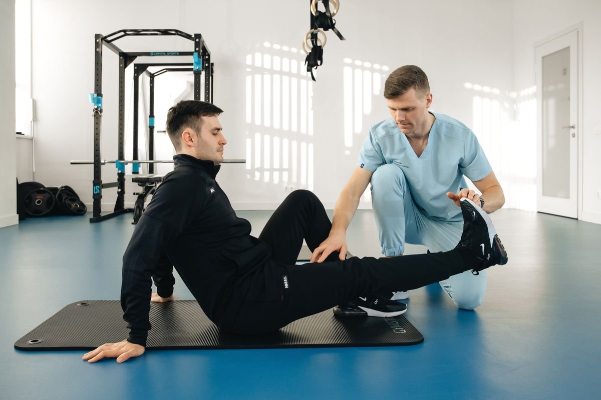 A physiotherapist coaching a patient through a seated exercise programme